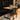 A table and chairs in a room with wood paneling
