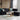 light candle on round white coffee table and sectional sofa