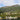 A lake surrounded by mountains and houses